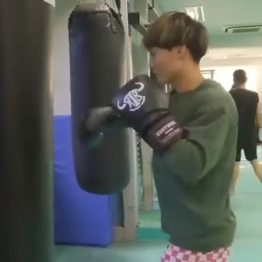 Japanese boxer training by using Krathing boxing gloves.